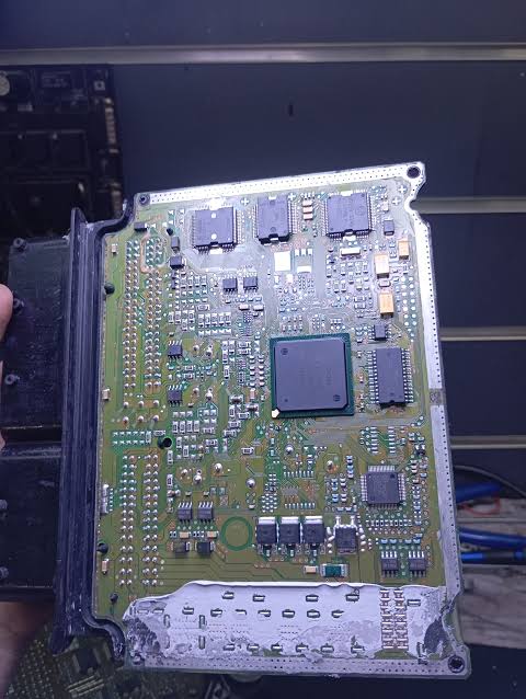 Opened control module with exposed circuit board and connector housing